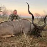 Photo of Hendrik with a large kudu prize.